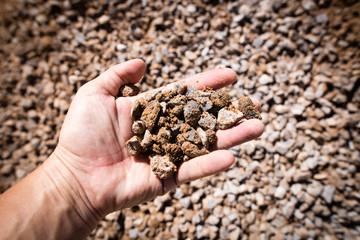 Building crushed stone with sand in hand