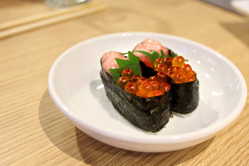 Salmon eggs or Ikura in Japanese style sushi fresh from raw salmond fish