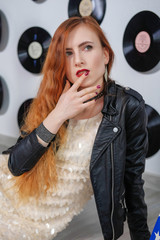 Plakat Sexy woman in a sequin dress, leather jacket and red lips. Disco style.