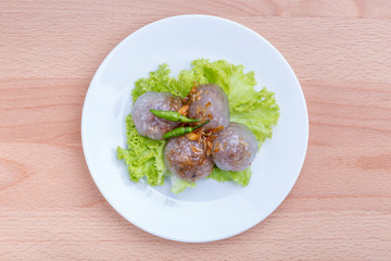 Tapioca sago balls with pork filling served with vegetable and chili, traditional Thai appetizer dish.