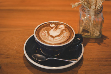 Coffee cup and coffee beans on table