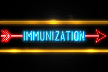 Fototapeta premium Immunization - fluorescent Neon Sign on brickwall Front view