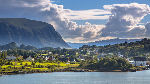 Norwegian village in fjord landscape on sunny day