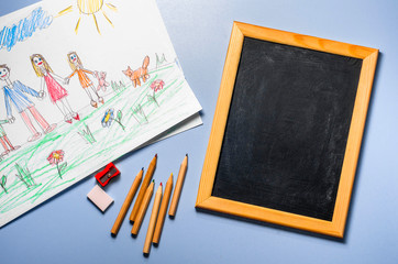 Children's drawing, colored pencils and chalk board, top view