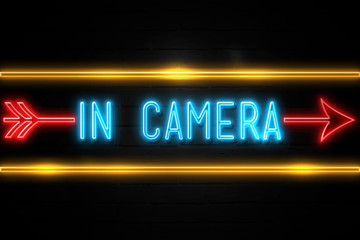 Obraz premium In Camera - fluorescent Neon Sign on brickwall Front view