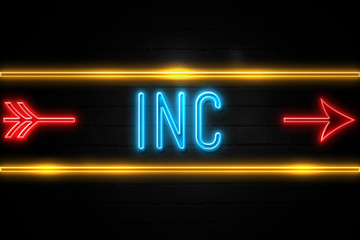 Obraz premium Inc - fluorescent Neon Sign on brickwall Front view