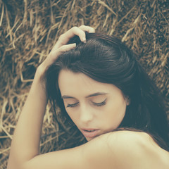 Woman with closed eyes and brunette hair