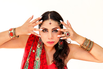 Woman dancing Indian dance in national dress. A handsome beautiful girl portrait in red Hindu...