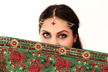Woman dancing Indian dance in national dress. A handsome beautiful girl portrait in red Hindu...