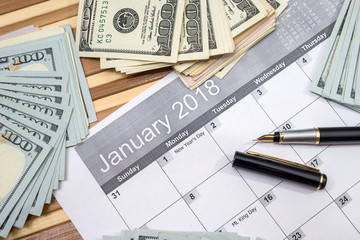 calendar, junuary 2018 with pen and dollar