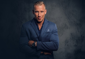 Studio portrait of a male dressed in a blue suit.