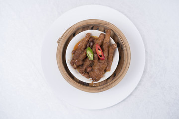 Chinese cooked chicken feet in a white plate