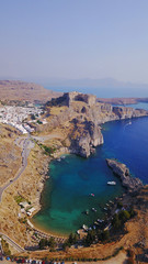 Aerial drone photo of iconic ancient Acropolis and village of Lindos, Rodos island, Aegean, Dodecanese, Greece