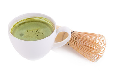 matcha powder in White ceramic spoon and Green tea matcha latte cup isolated on white background