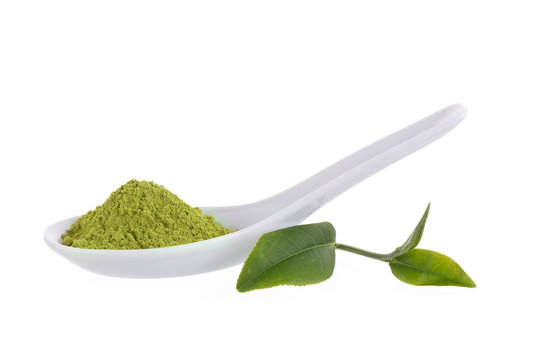 matcha powder in White ceramic spoon isolated on white background