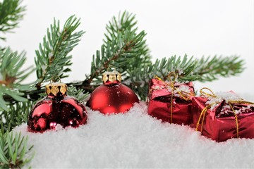 An image of red christmas balls with snow
