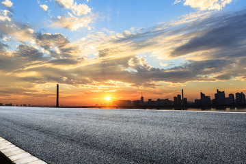 Asphalt highways and city buildings at sunset