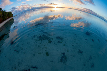 Sunset on polynesian white sand beach