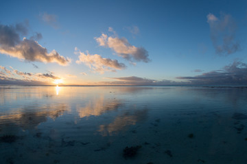 Naklejka na ściany i meble Sunset on polynesian white sand beach