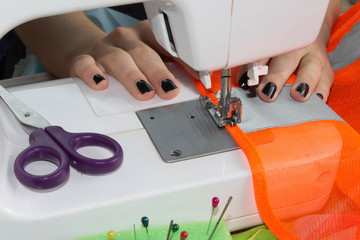 Dressmaker woman working with sewing machine