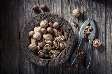 Tasty walnuts and hazelnuts with on rustic wooden table