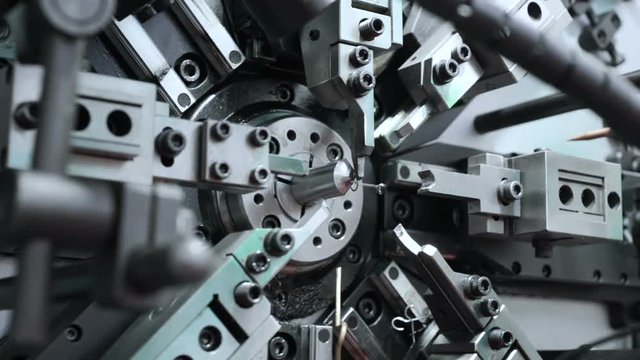 The work of the mechanism of automatic CNC bending machine. Manufacture of a spring of fine wire