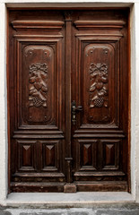 Beautiful old door with ornament of carved wood brown.