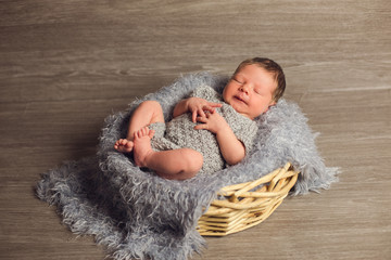 a newborn baby boy in a basket