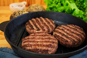 Ingredients for burger. Beef meat cooked on the grill