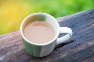 cup of coffee in morning on wooden table.