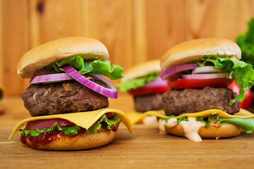 Delicious handmade burger on wooden background