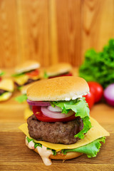 Delicious handmade burger on wooden background