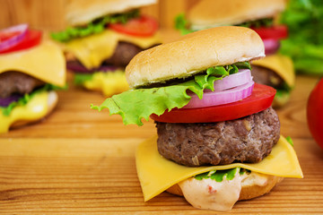 Delicious handmade burger on wooden background