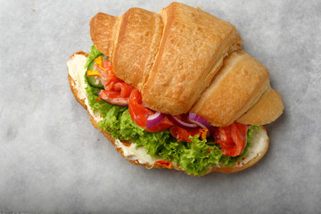 Morning croissant with cheese and fish