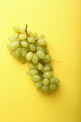 Green grapes on yellow background