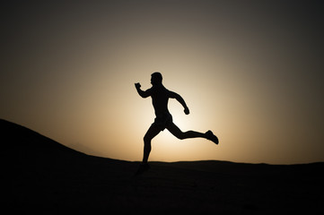 silhouette or man runner, guy running outdoor at clear sky