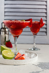 Strawberry daiquiri cocktail with lime and ice cubes. Space for text. Top view