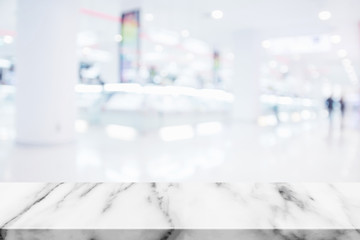 Empty top of marble table with blur shopping mall background.