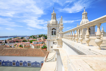 Spectacular lisbon aerial view of 25 April Bridge, Tagus River and colorful Alfama neighborhood from roof top of popular Church or Monastery of Sao Vicente of Fora. Lisbon capital, Portugal, Europe