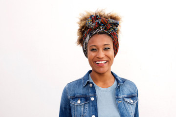 Close up smiling black woman wearing headscarf standing against white background