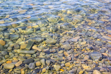 Sea and pebbles underwater in a beach. Pebble background