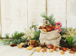 Fototapeta na wymiar New Year or Christmas composition with walnuts, mulled wine, hazelnuts
