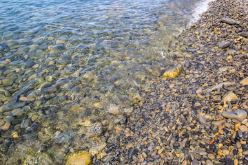 Sea and pebbles underwater in a beach. Pebble background