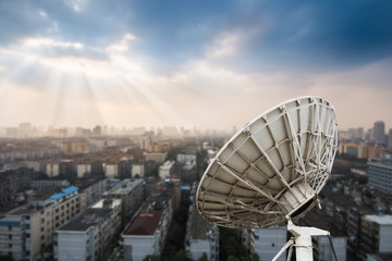 In the city night background large satellite antenna
