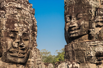 Ancient stone smiling faces of the Prasat Bayon Wat temple in the jungle, Angkor wat, Cambodia....