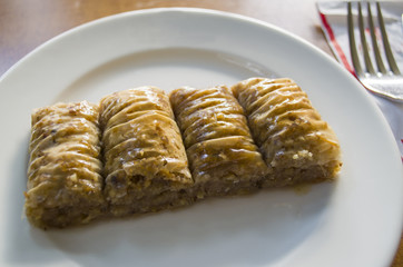 traditional Turkish arabic dessert - baklava with honey and nuts