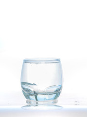 cool water, Ice cubes splashing into glass of water, water splashing from ice cubes being dropped in a glass.