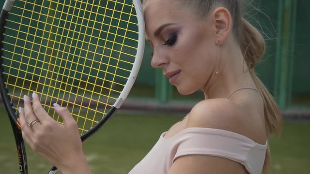 Sexy tennis girl posing at the camera