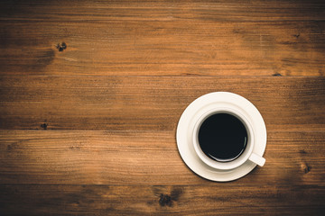 Empty coffee cup on wooden background