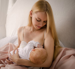 Breatfeeding baby. Mother nursing her child. Newborn eat breast milk.